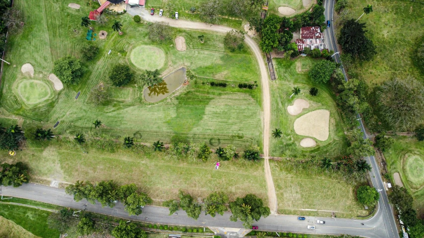 an aerial view of a golf course with lots of green grass