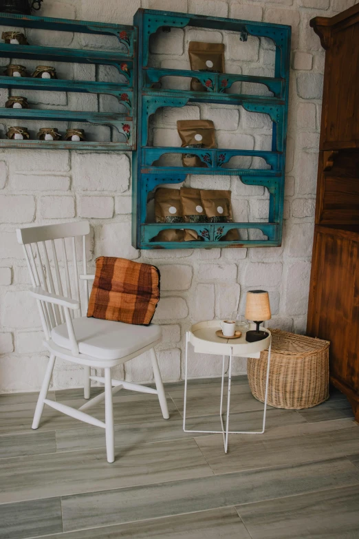 a room with two chairs a table and a wall shelf