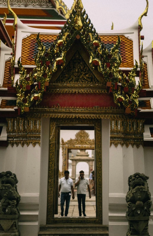 a very large mirror with men standing in front of it