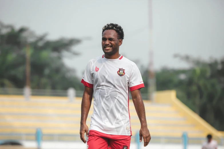 a man is posing for the camera while on the soccer field