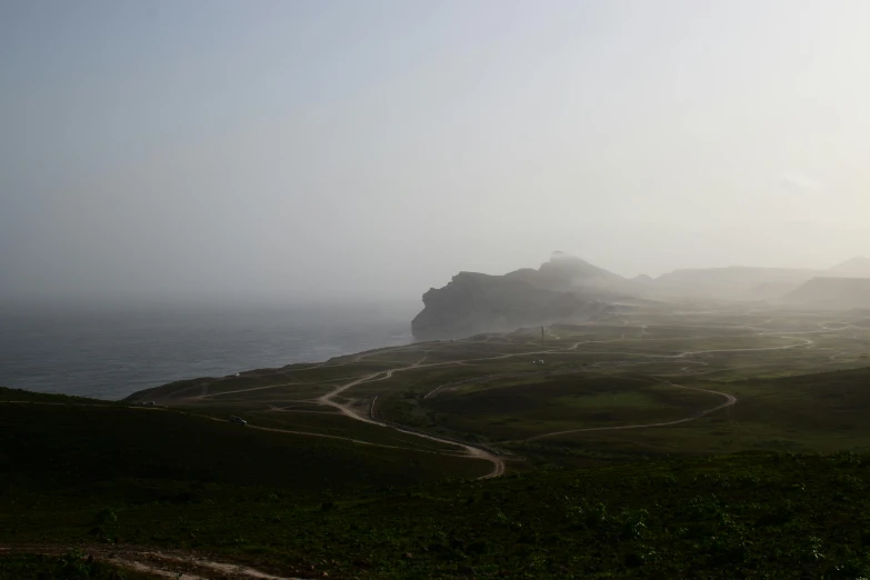 some very scenic cliffs and grassy field by the ocean