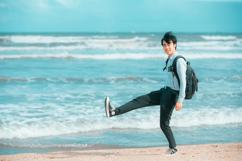 a man in an old fashioned shirt and backpack kicking up a frisbee