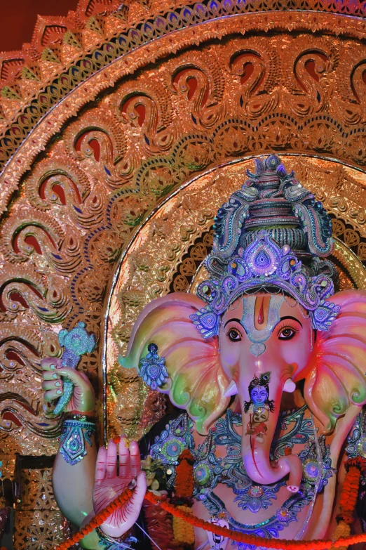 a large elephant statue stands behind a mirror