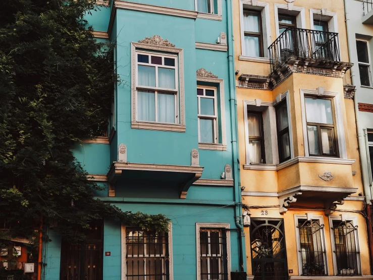 multiple multi - colored houses on one corner of street