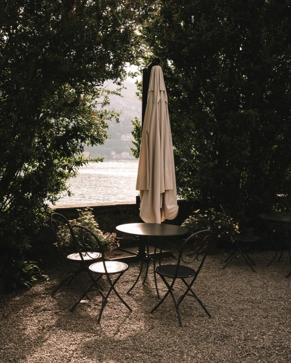 a table with an umbrella on top is in the sun