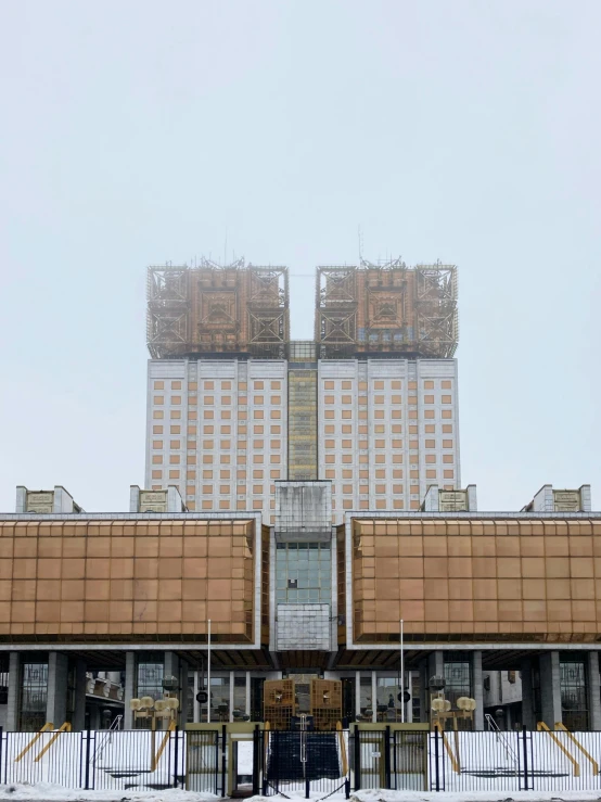 a large building sitting on the side of a road in the snow