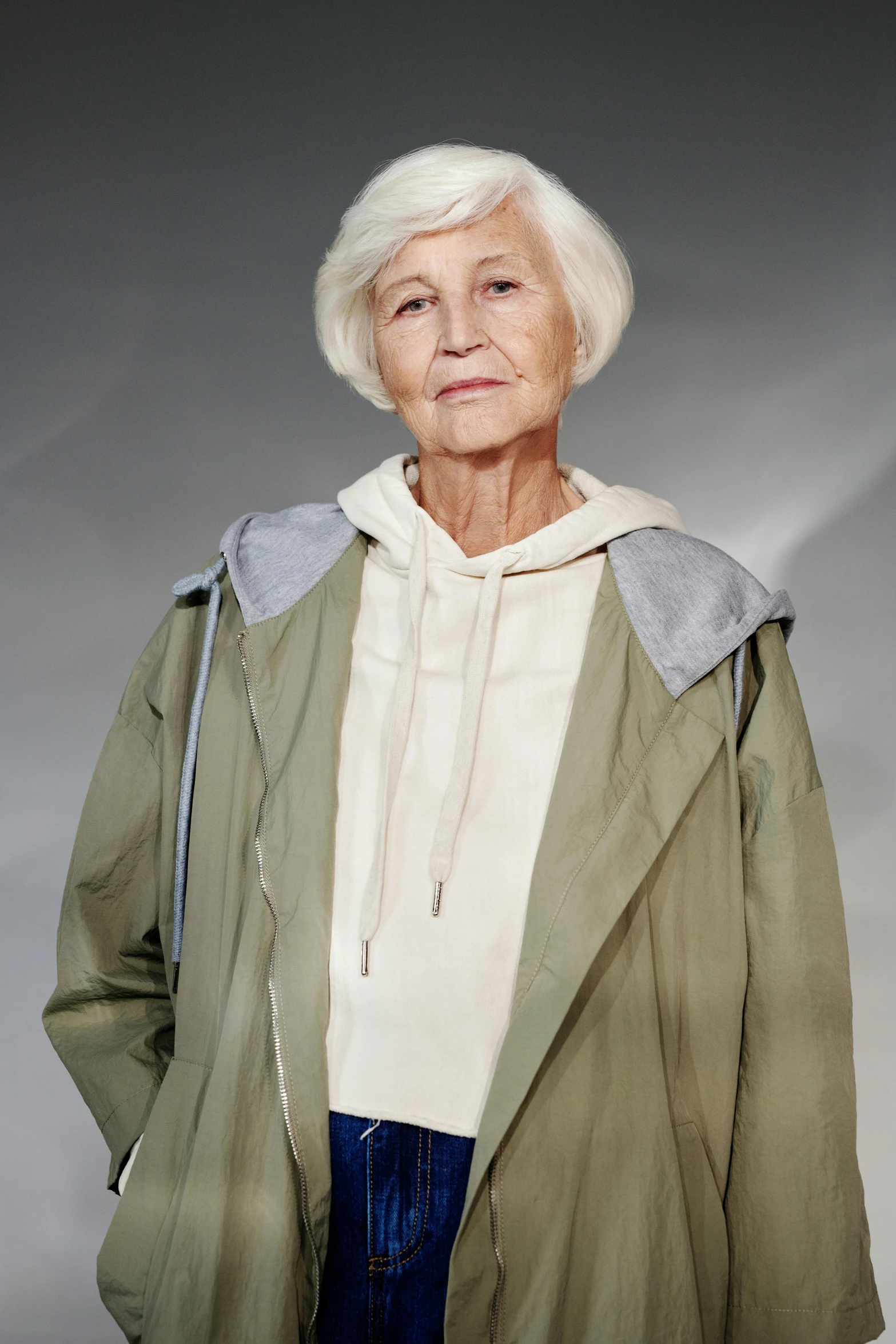 an older woman in green jacket and blue pants