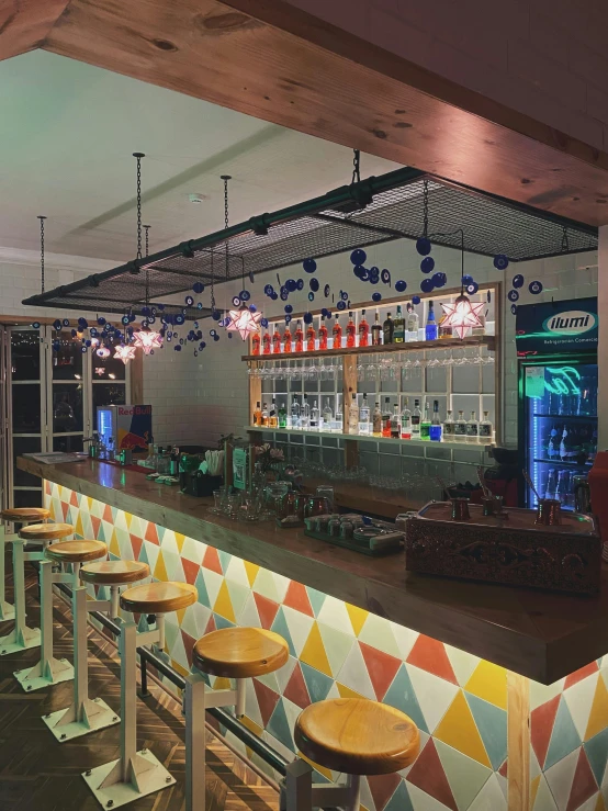colorful tile bar with long stools and a bar