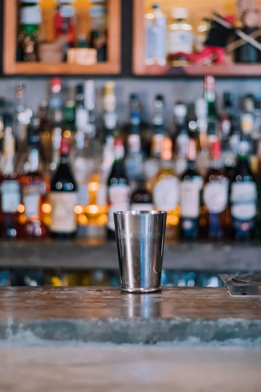 a metal s cup sits on a bar counter