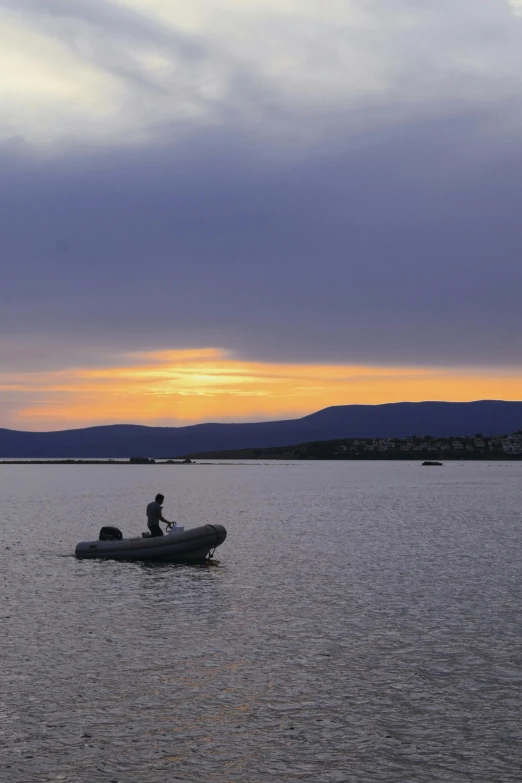 the two people are riding in the small boat