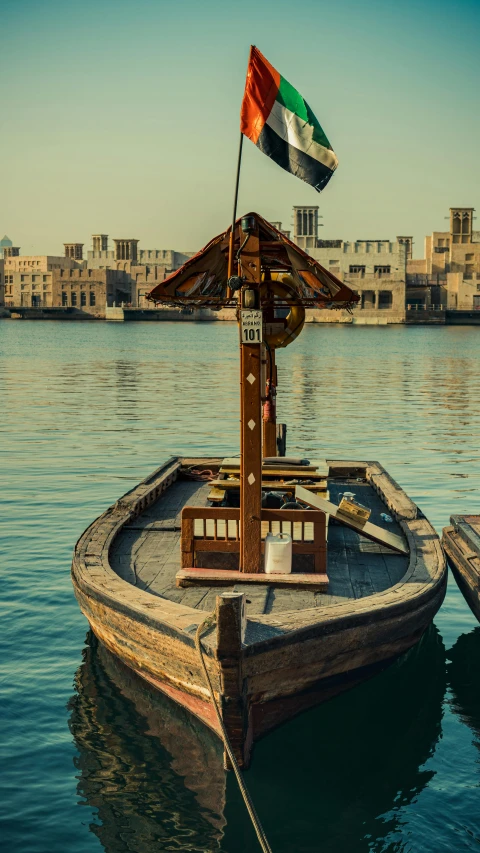 a boat with a italian flag on it floating in the water