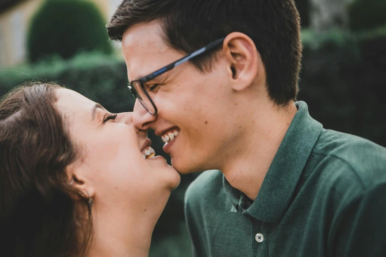 an engaged couple smiling as they share a tender moment