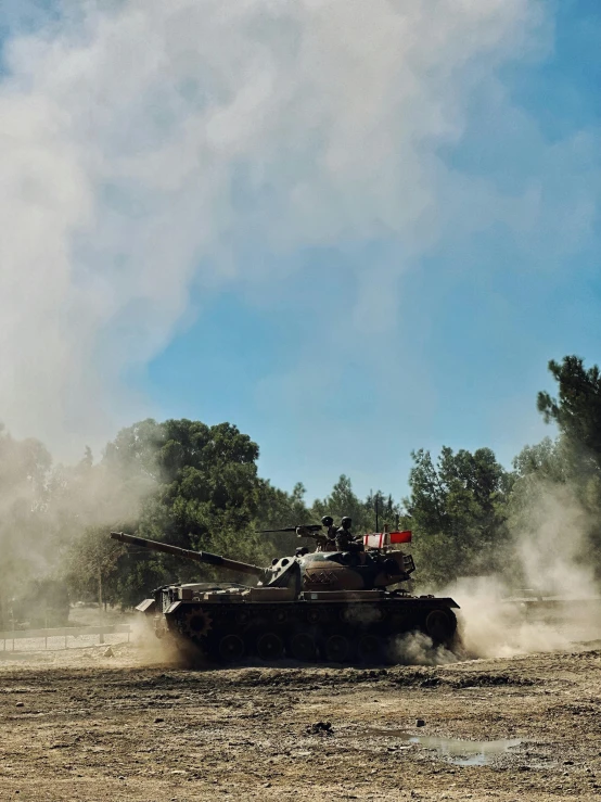 tanks going down the road in a dirt field