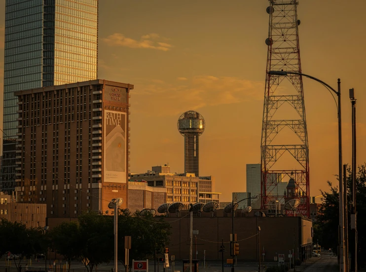 the clock tower stands beside the city skyline