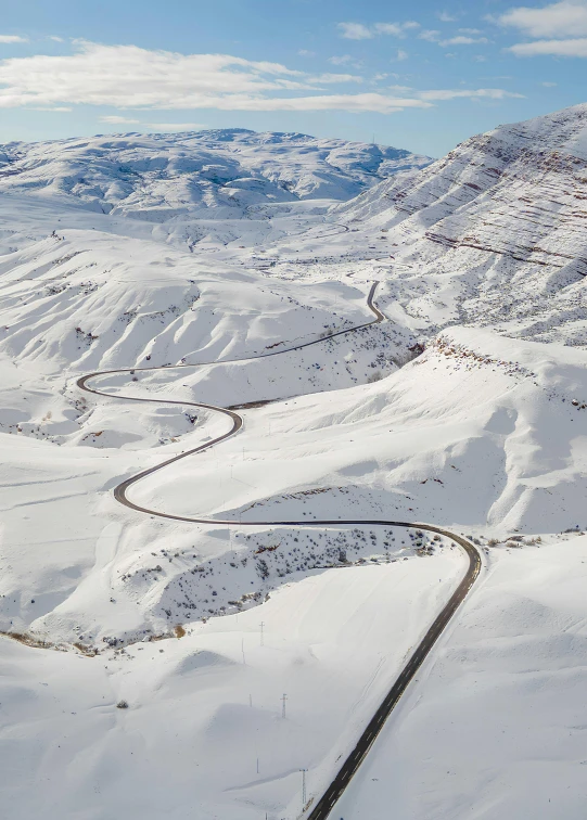 a scenic winter landscape showing snow covered mountains