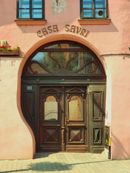 an entrance to the building is wooden and decorated