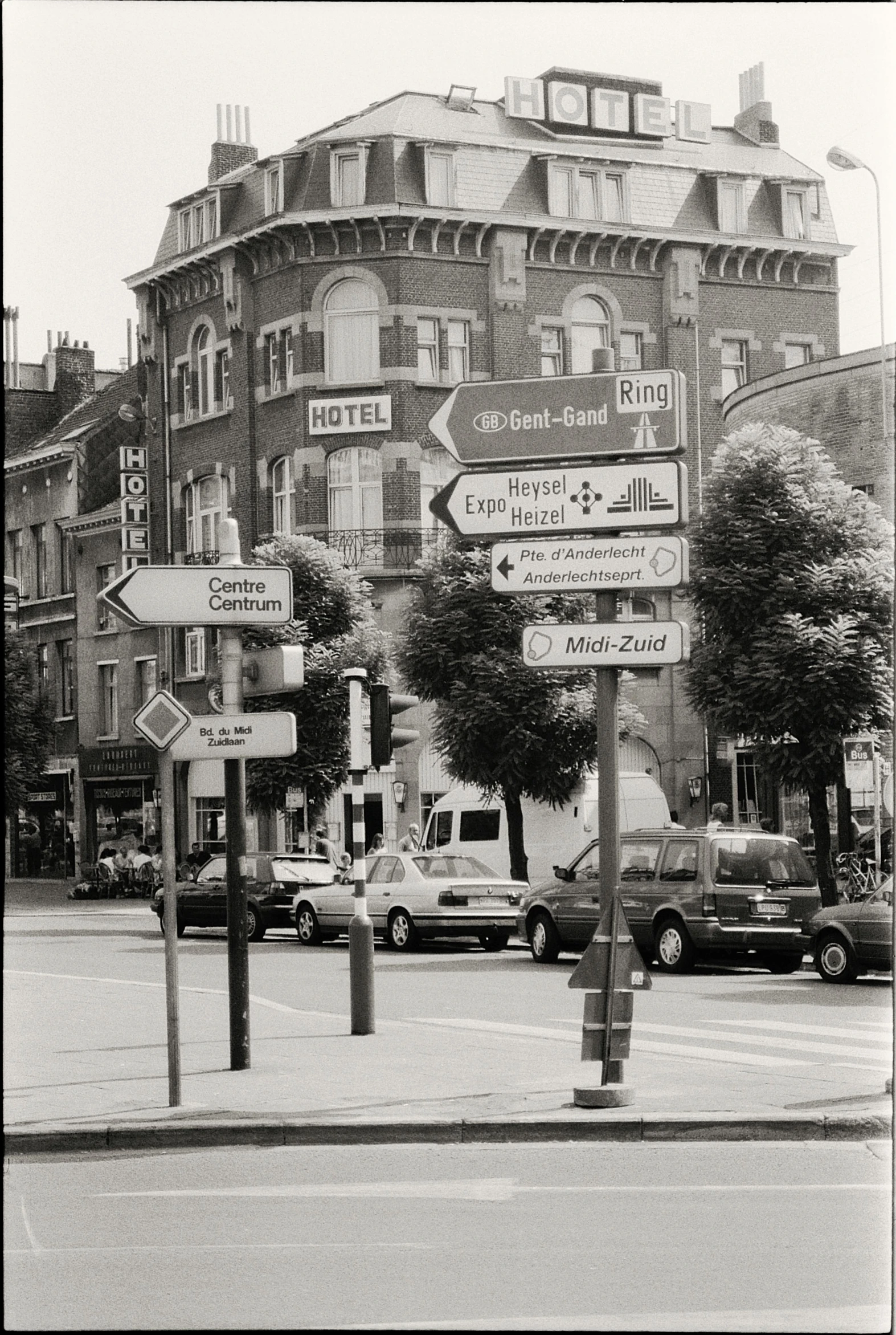 signs pointing to cities are displayed in a black and white po