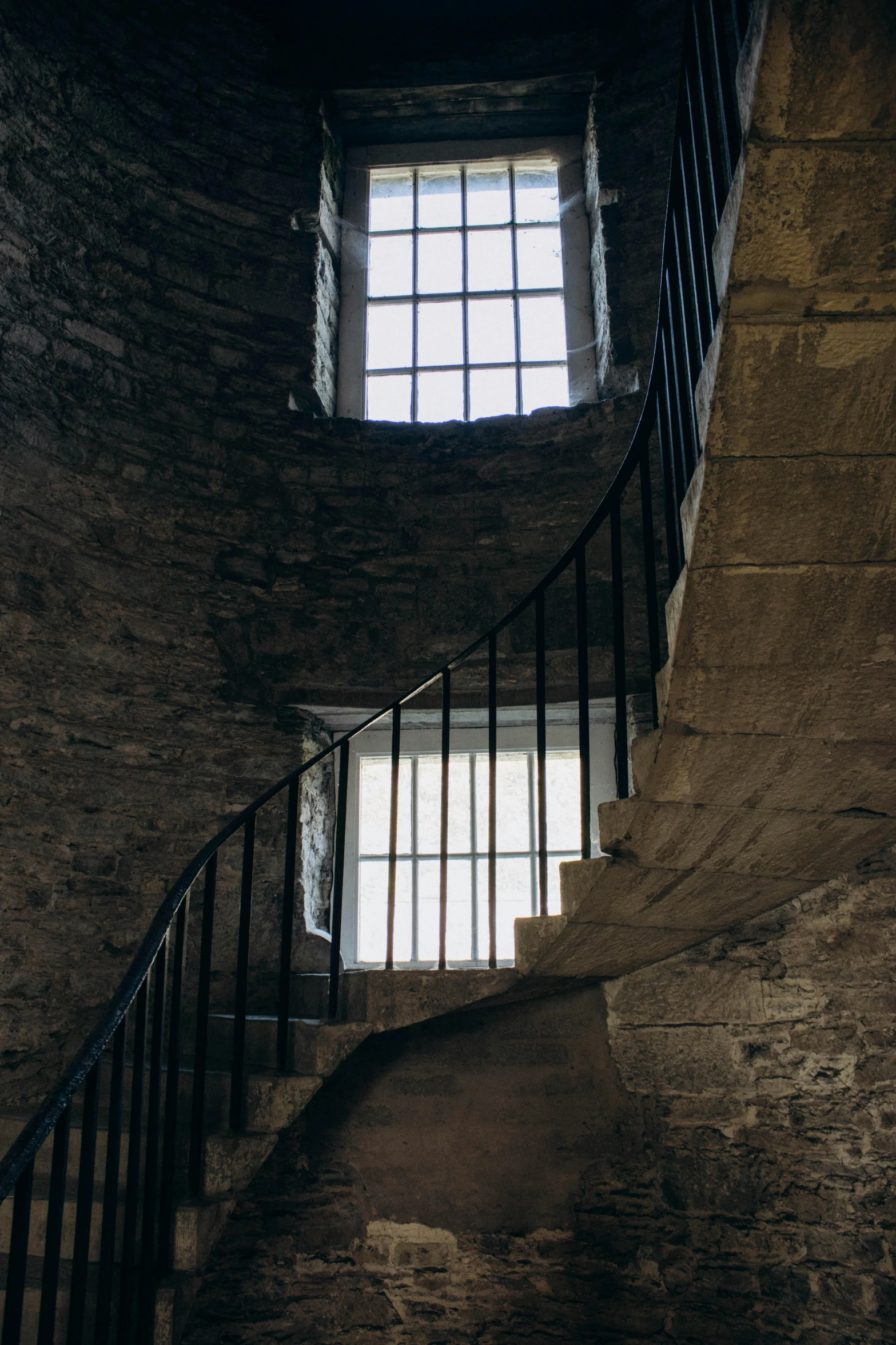 a window with bars is above a stair case