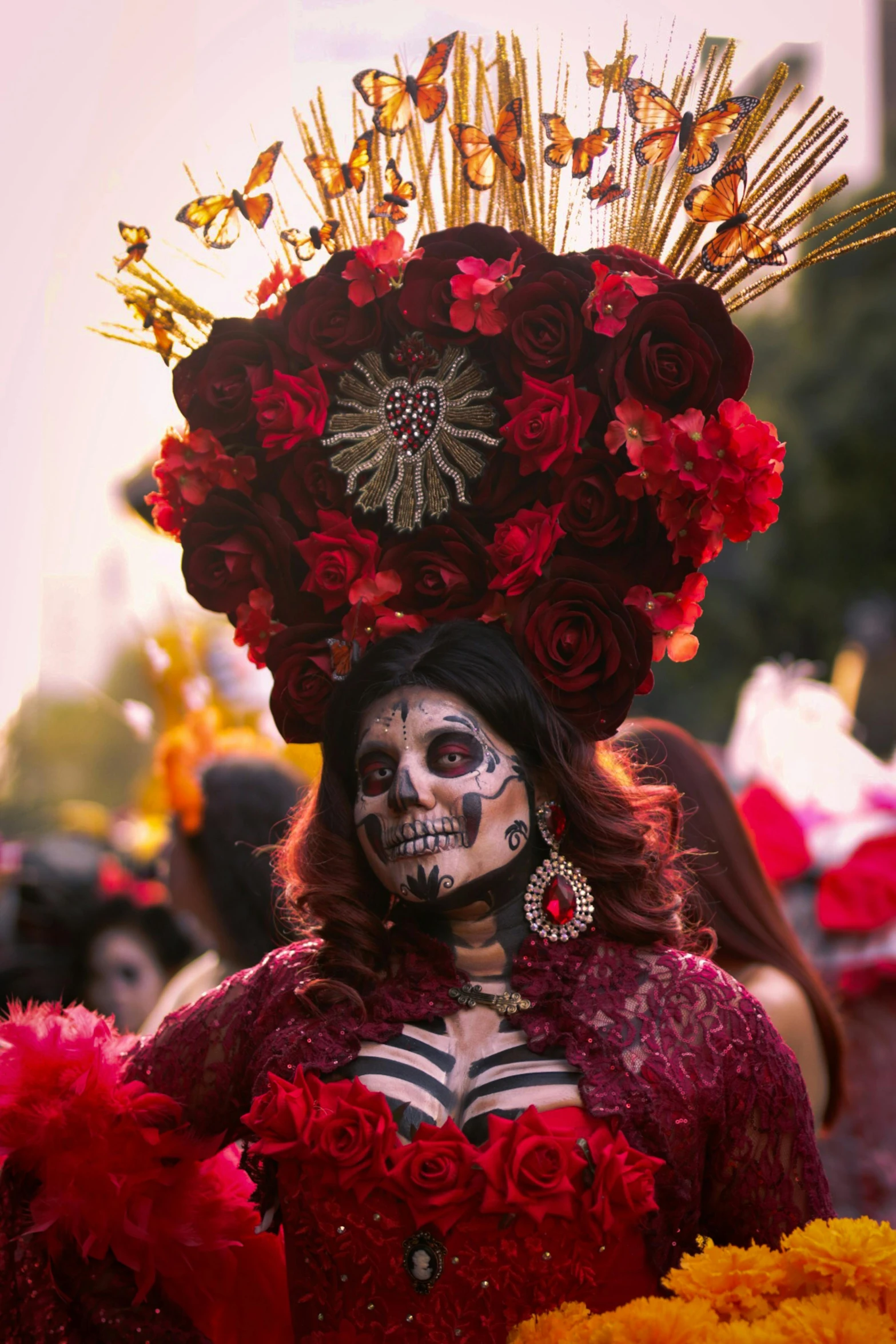 woman dressed in elaborate costume, with red flower decorations