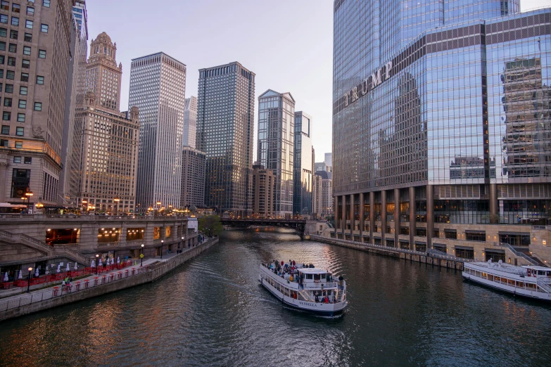 boat on river in urban waterway with buildings and reflections