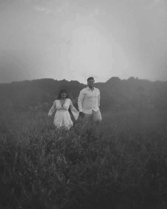 two people in a field in the dark