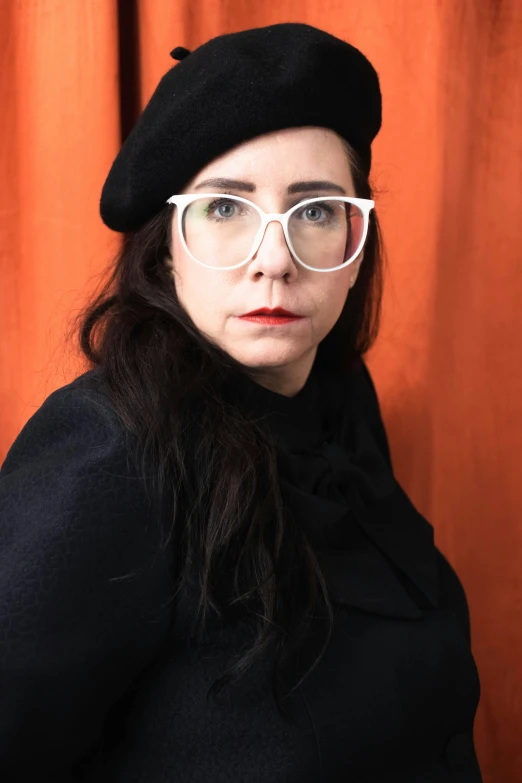 a woman wearing a black hat and glasses