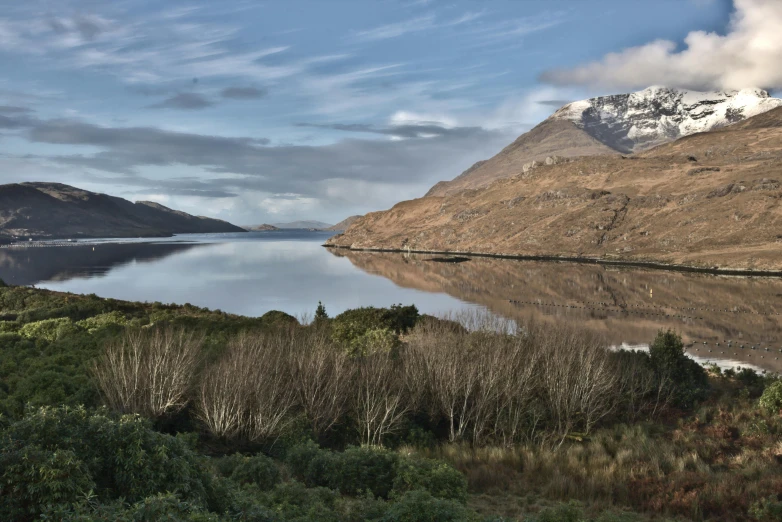 a lake is surrounded by the mountains