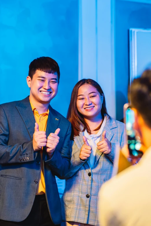 an asian couple making funny faces together in the night