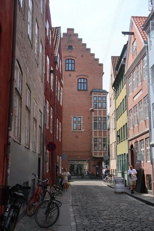 a small brick alley way with a couple of bikes parked next to each other