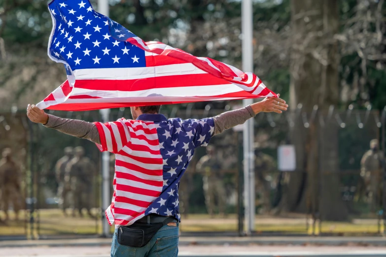 a man is holding a flag that looks like the american flag