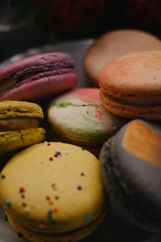 different types of cookies with sprinkles are piled on top of each other