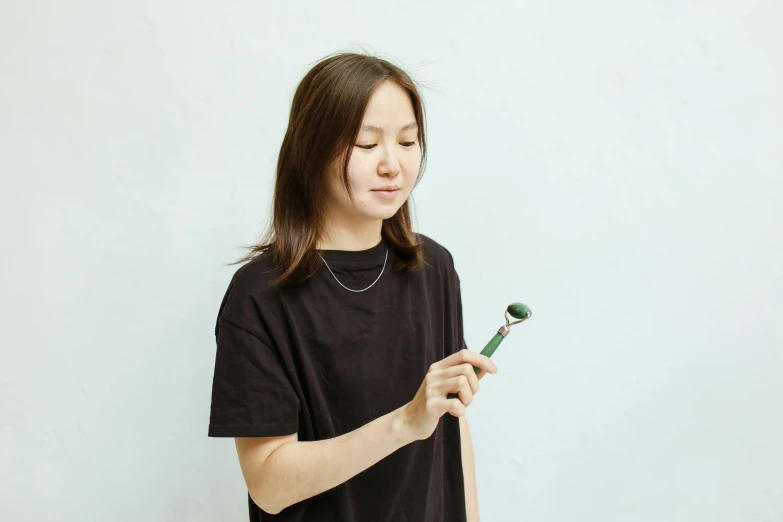 girl holds a flower and looks down