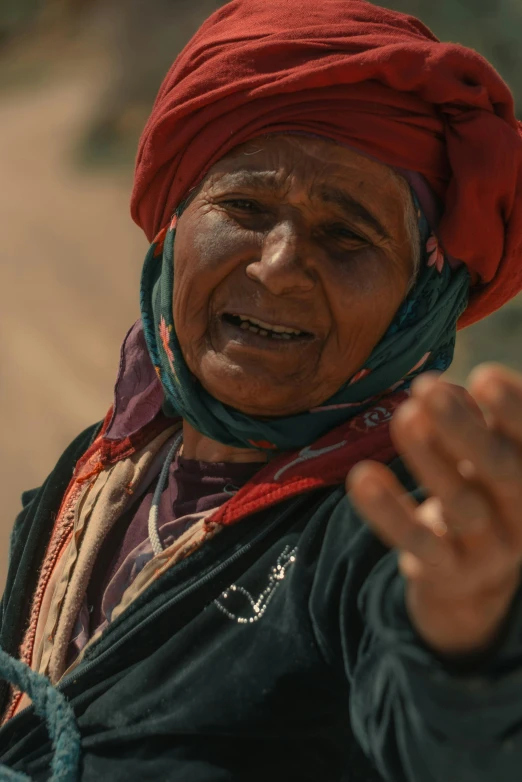 an old woman with her hands out in the air