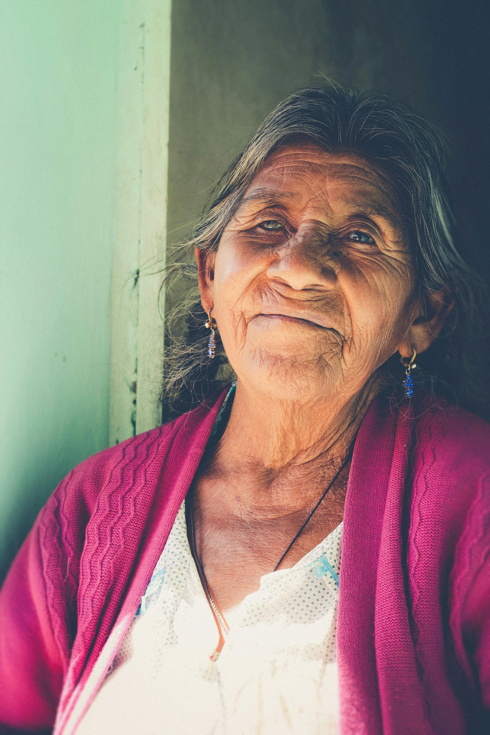 a woman with long hair is staring off into the distance