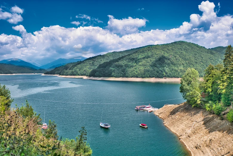 a beautiful lake with many small boats in the water