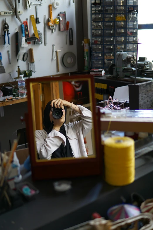 a person taking a po with a camera in a mirror