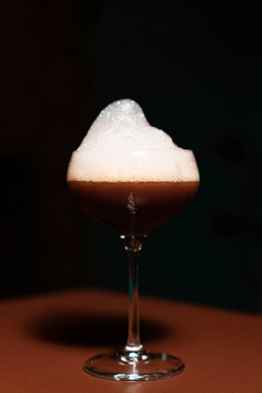 a dessert with white frosting in a martini glass