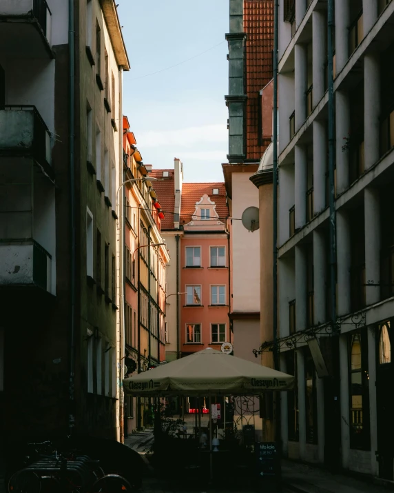 people and cars are walking through the narrow street