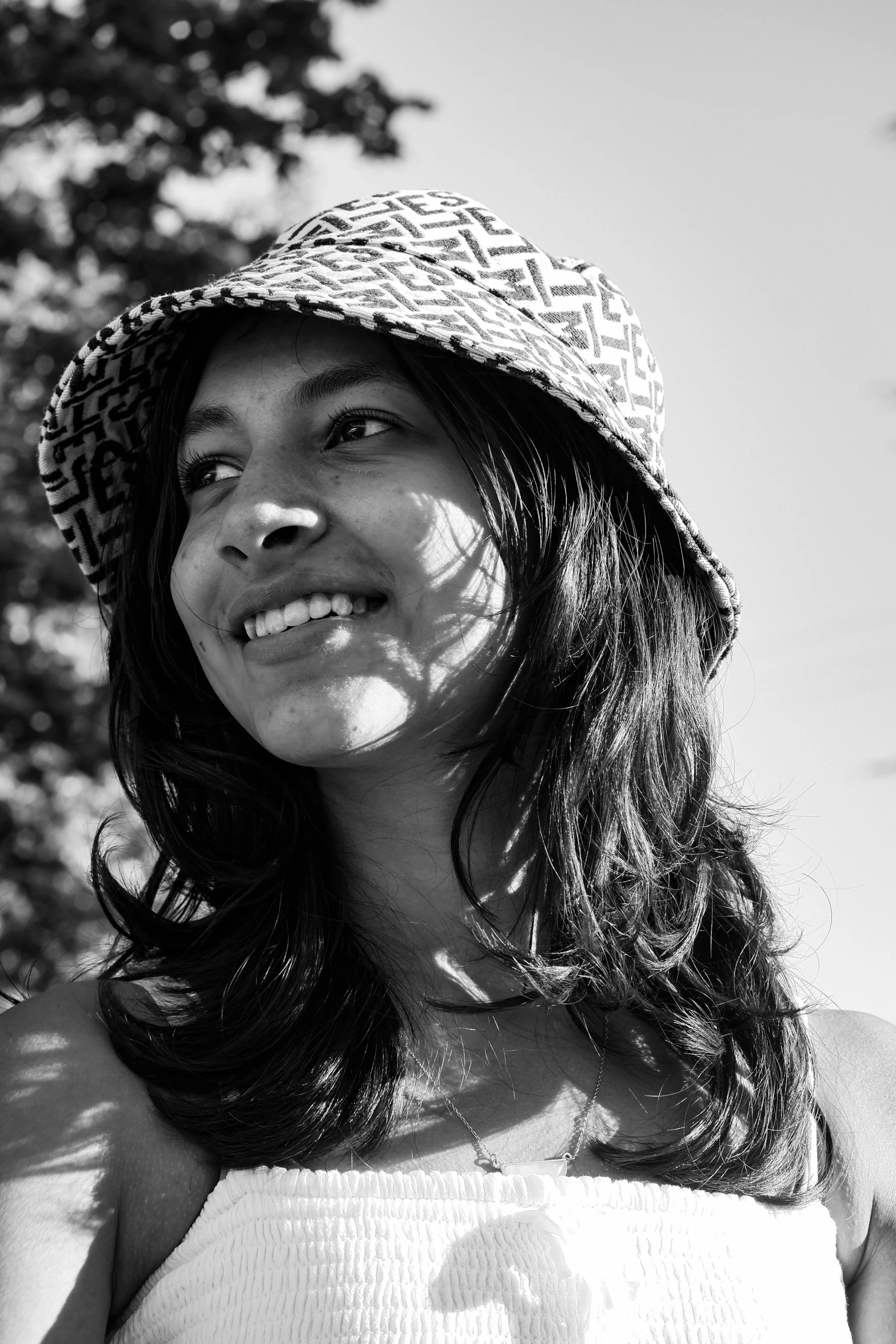 a woman in a straw hat smiling for a po