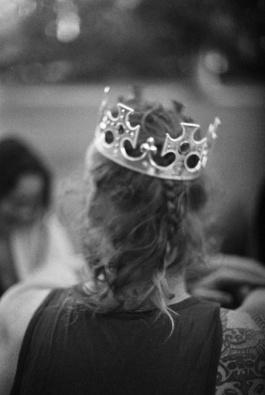 a  wearing a crown is seen in the middle of black and white