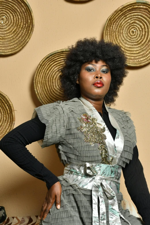 a woman posing in front of a backdrop