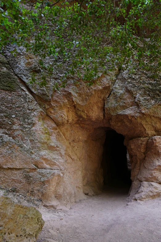 a dark tunnel in a big rocky wall