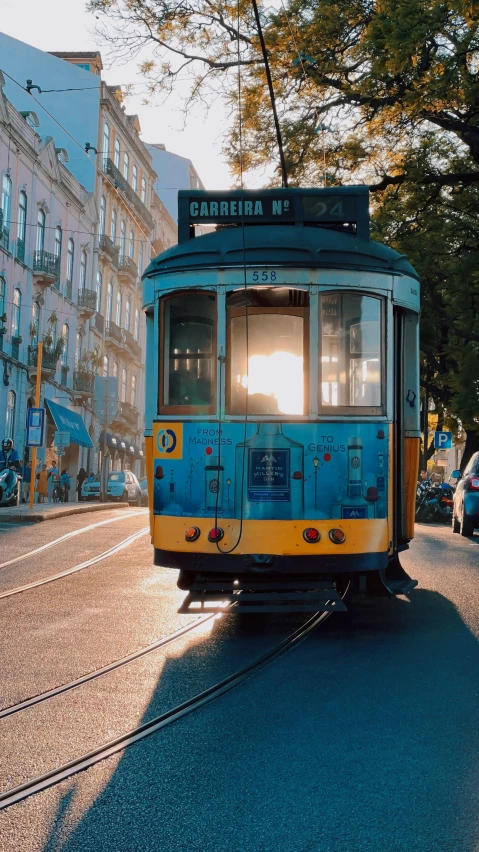 the trolley is traveling down the street through traffic