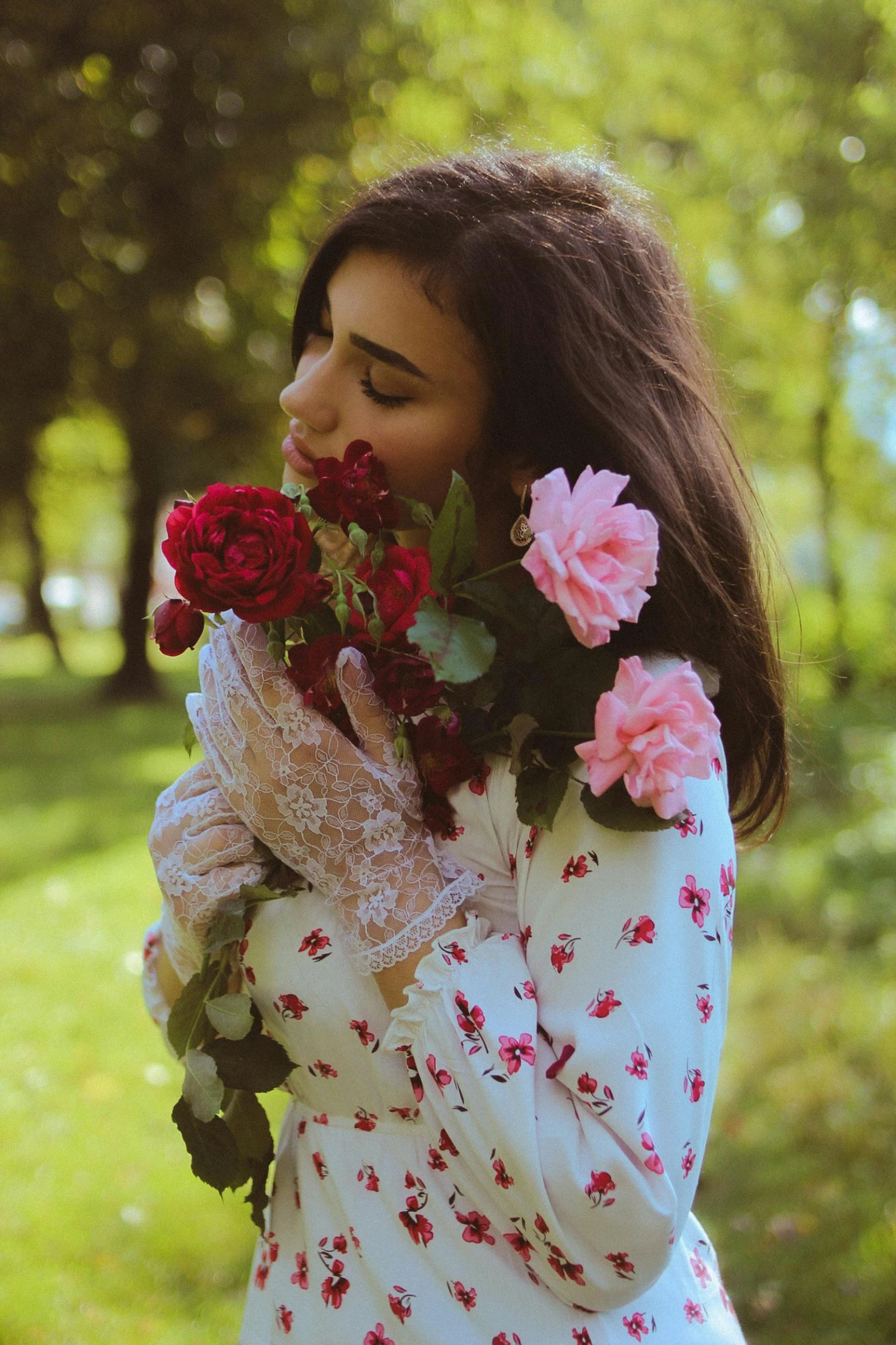 a woman with flowers on her shoulders holds a bouquet of roses