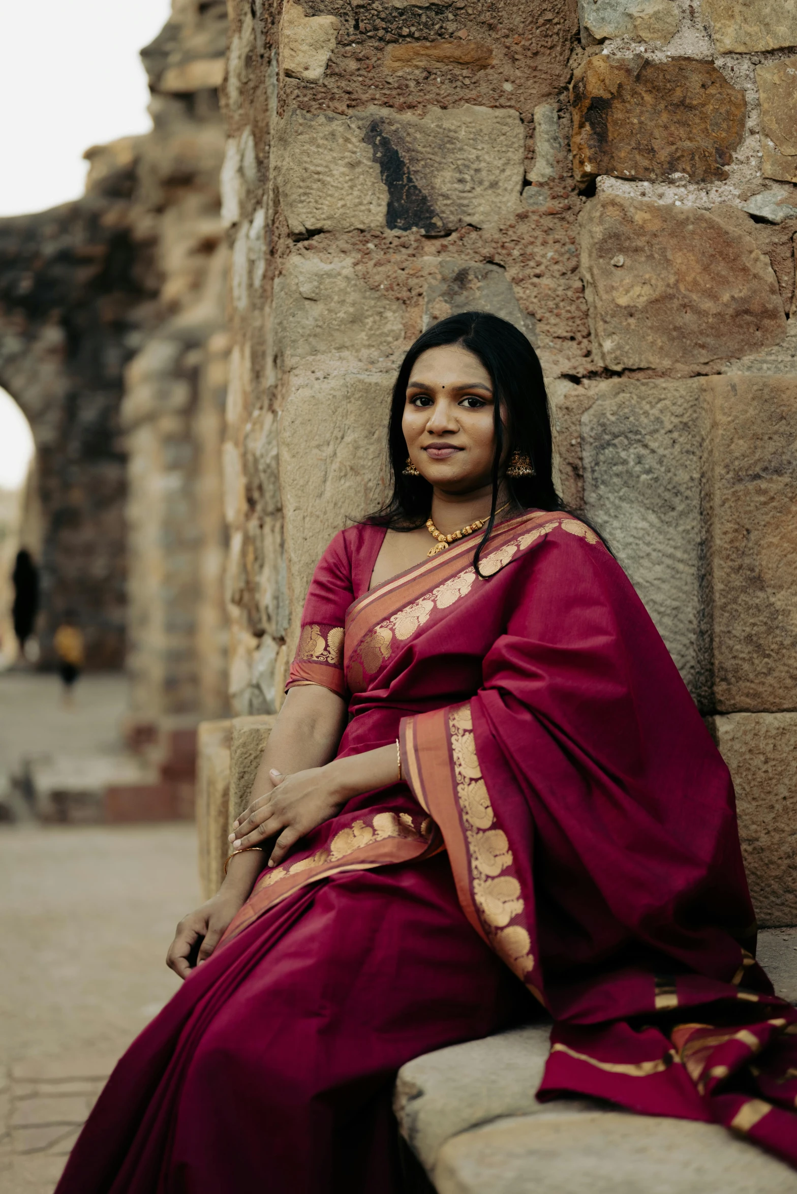 a young woman dressed in a purple sari