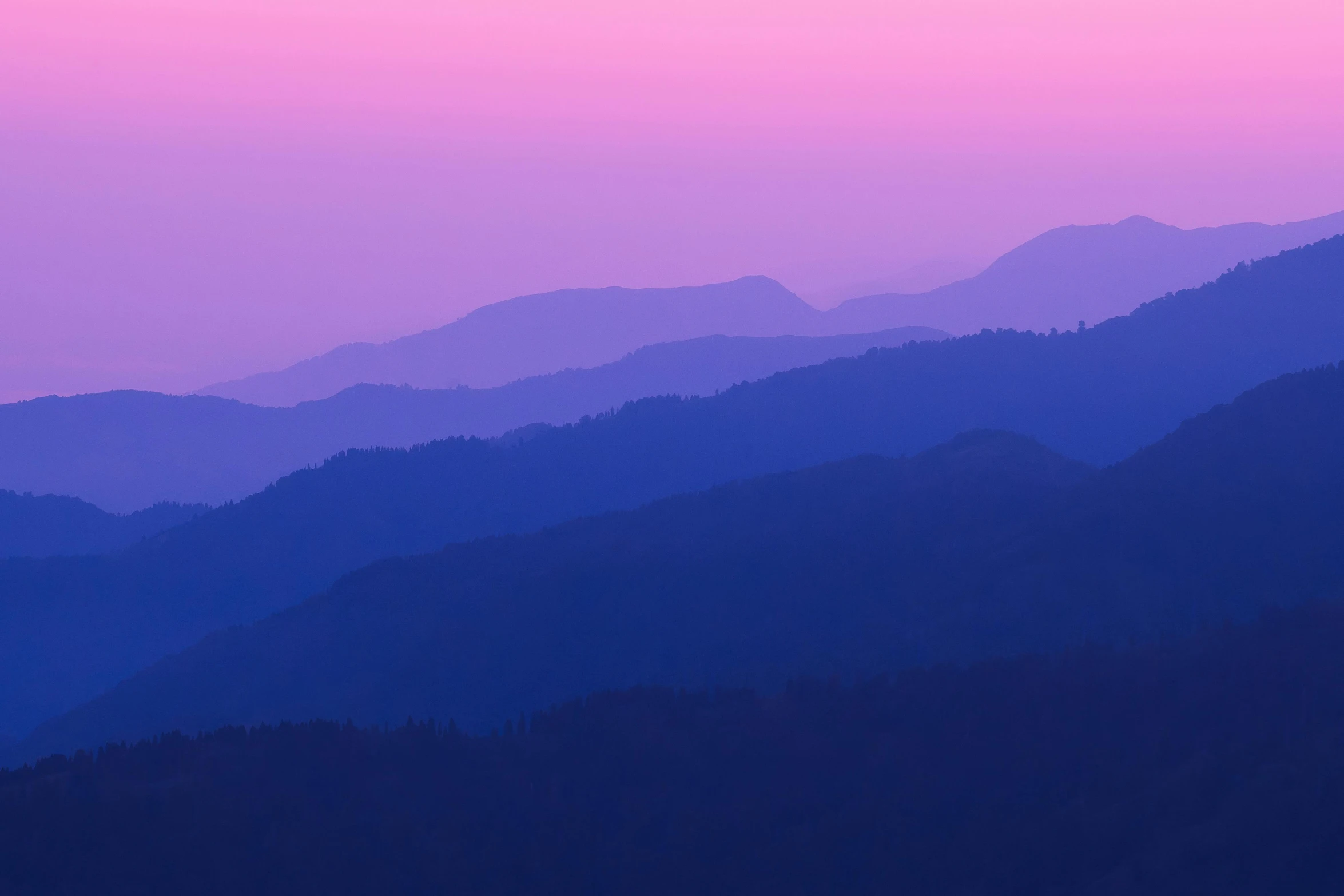 view of mountain range in the distance with pink sky