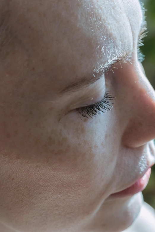 a woman with a pair of lashes on her nose