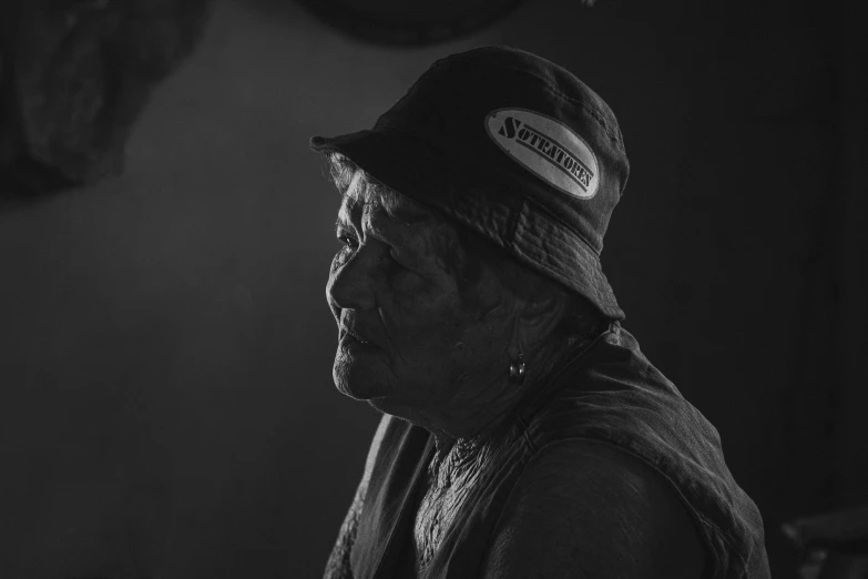 an older woman is standing in a dark room