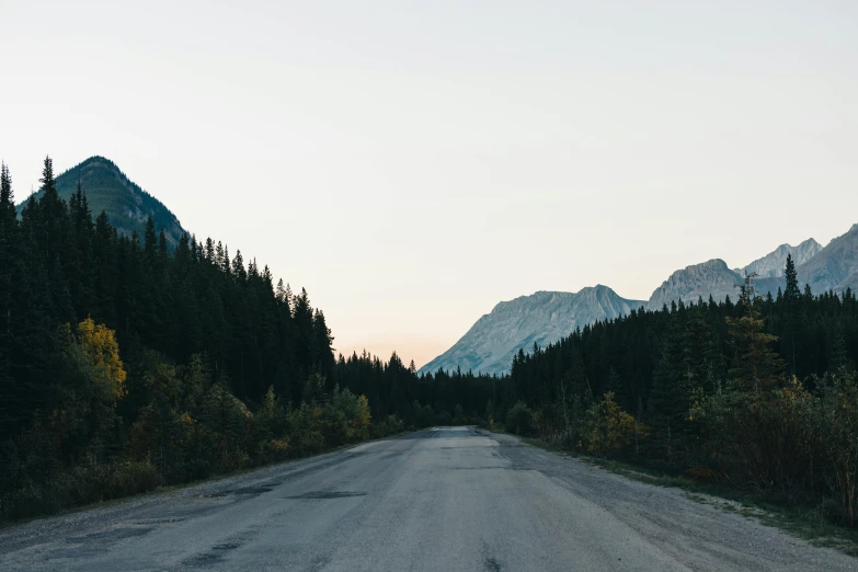 a dirt road with mountains in the distance