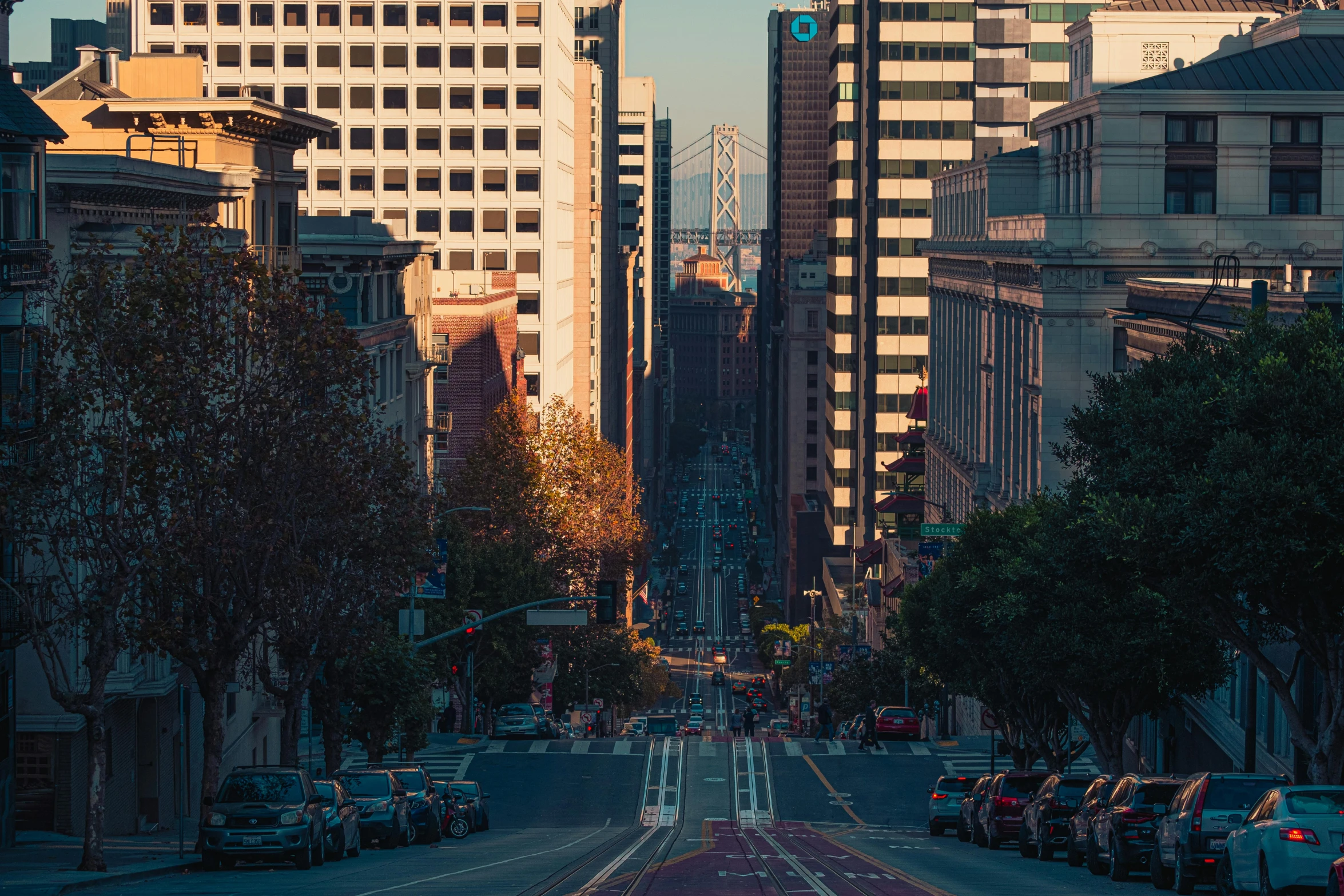 a very wide city street with tall buildings and traffic